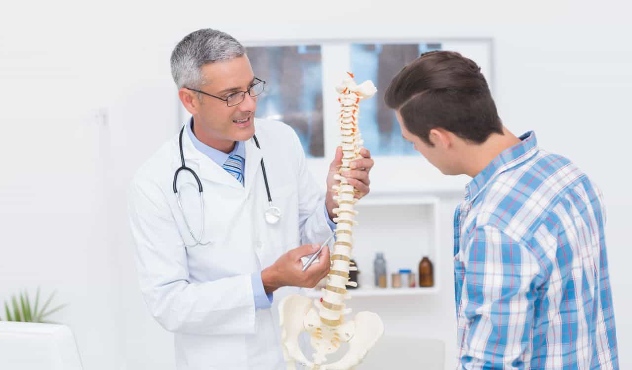 Doctor explaining the spine to his patient