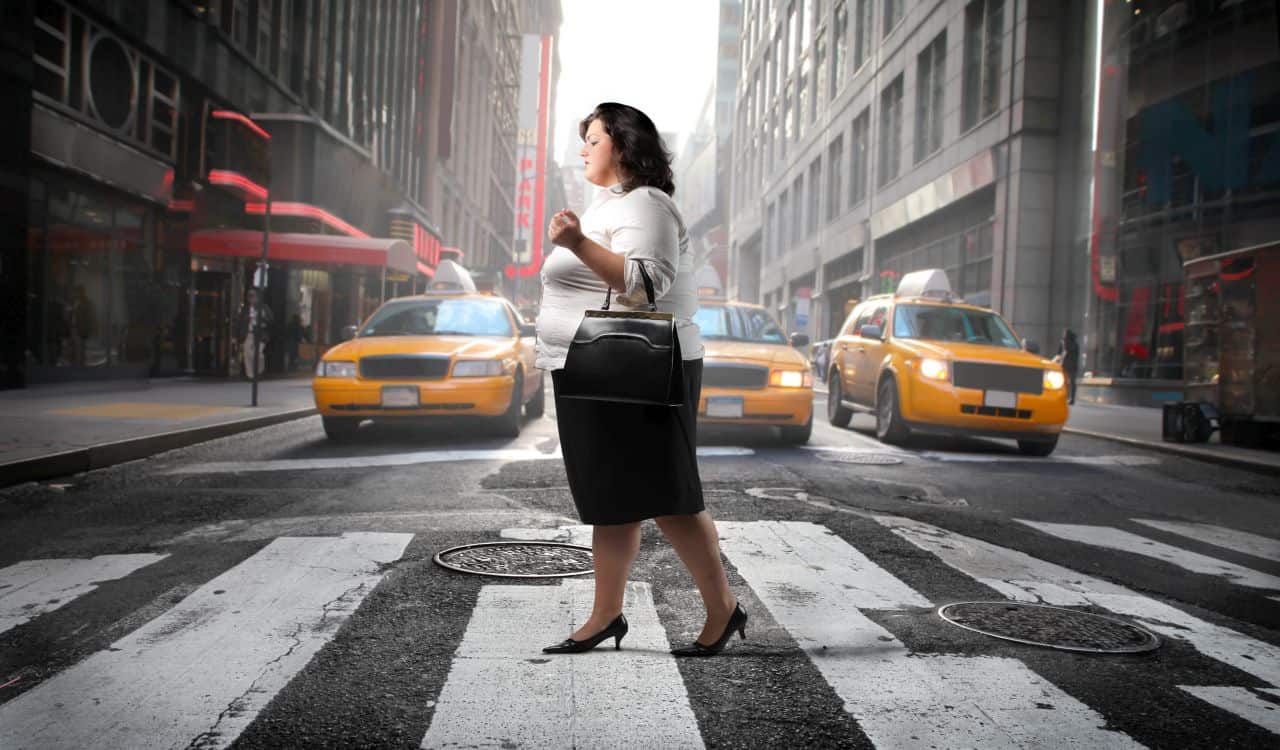 Overweight Woman Walking On The Street