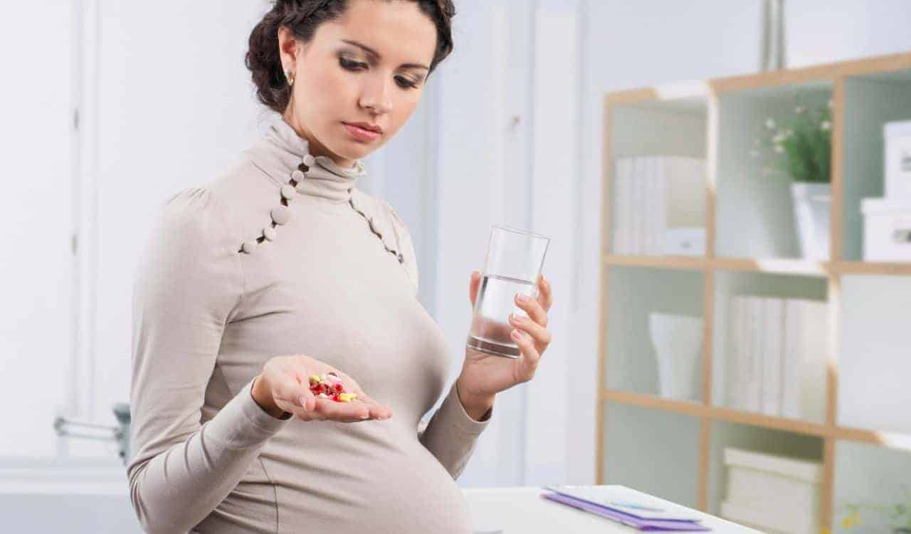 Pregnant Woman Takes Prenatal Supplement