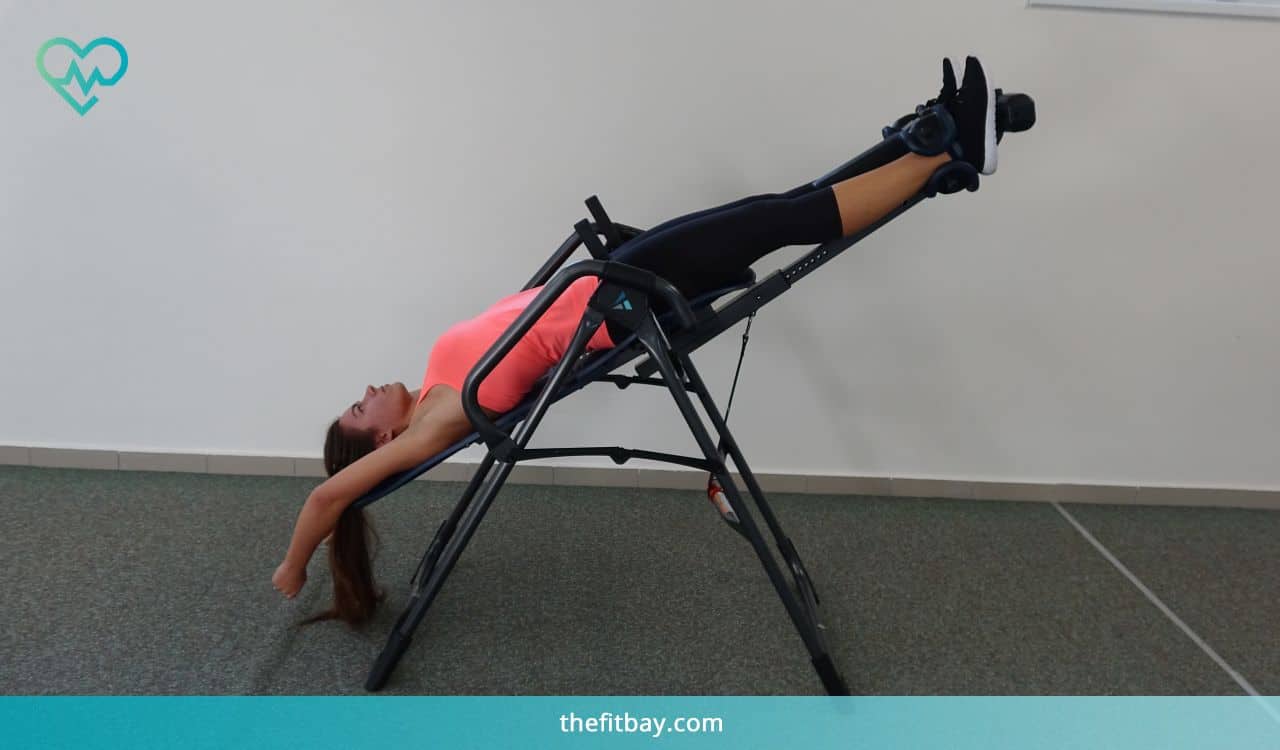 Woman Exercises On Inversion Table