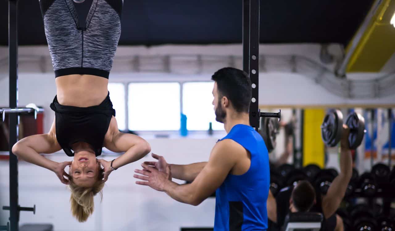 Woman Hanging Upside Down and Doing Abs