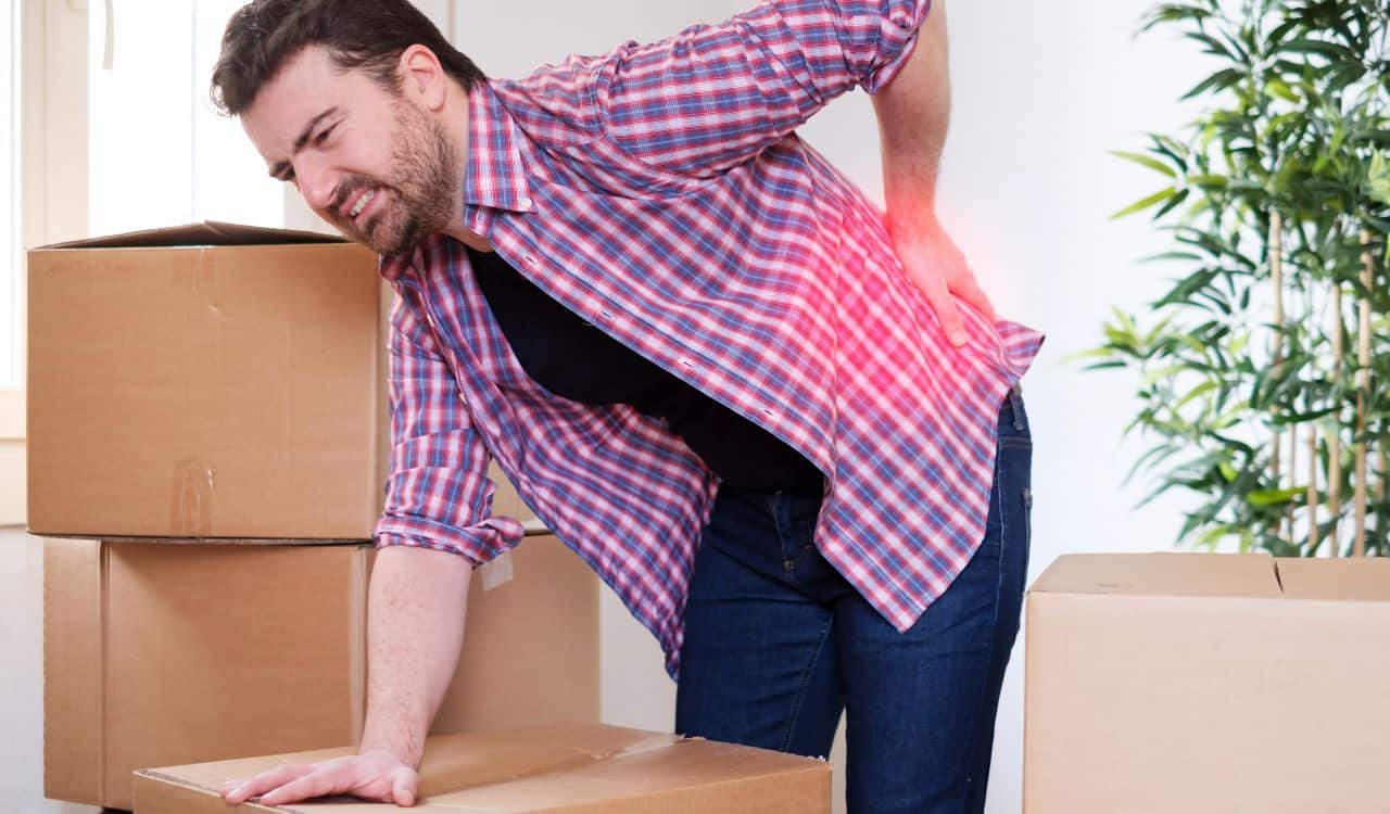 Man Suffering Back Pain During Moving Things