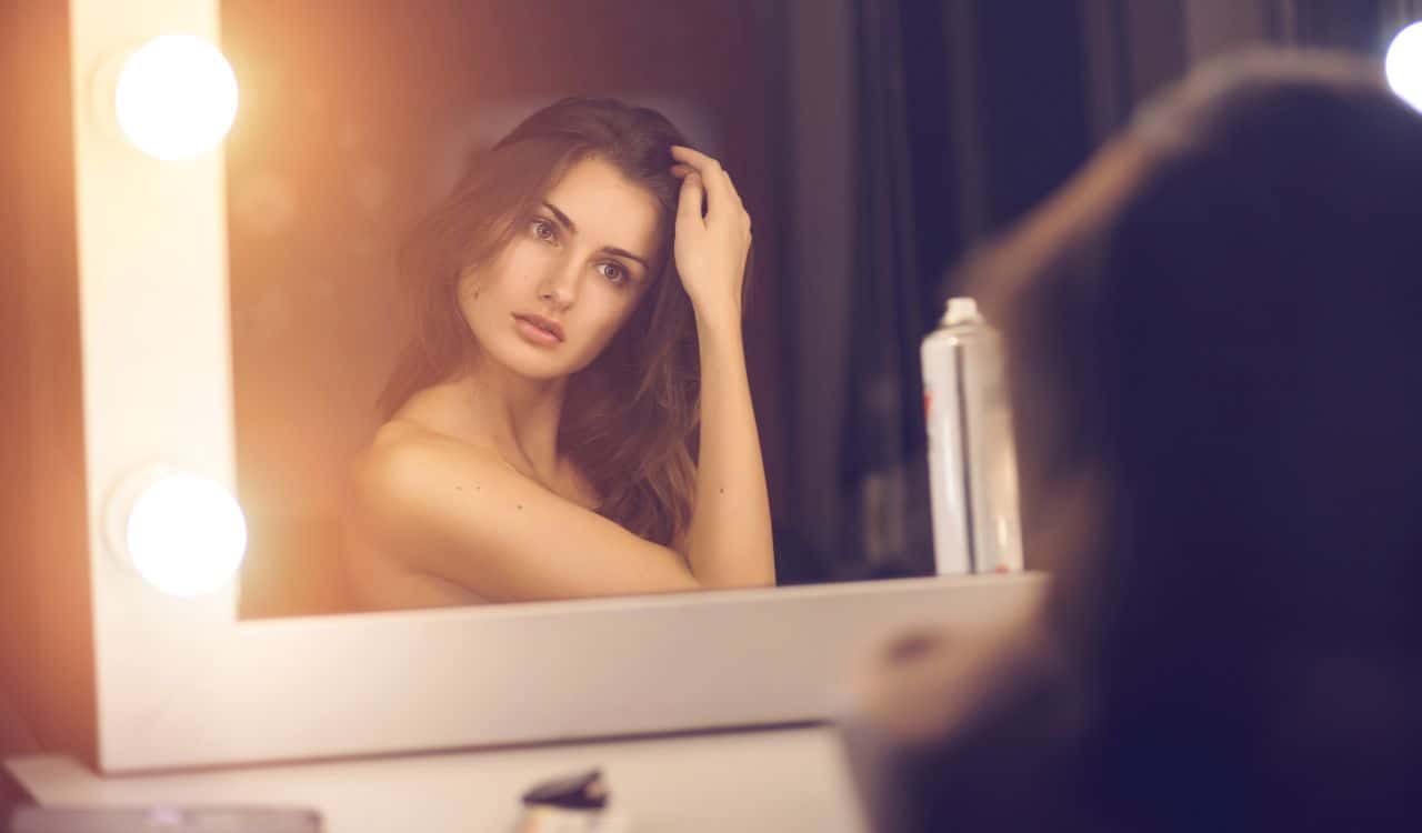 Young Woman In Front Of Mirror