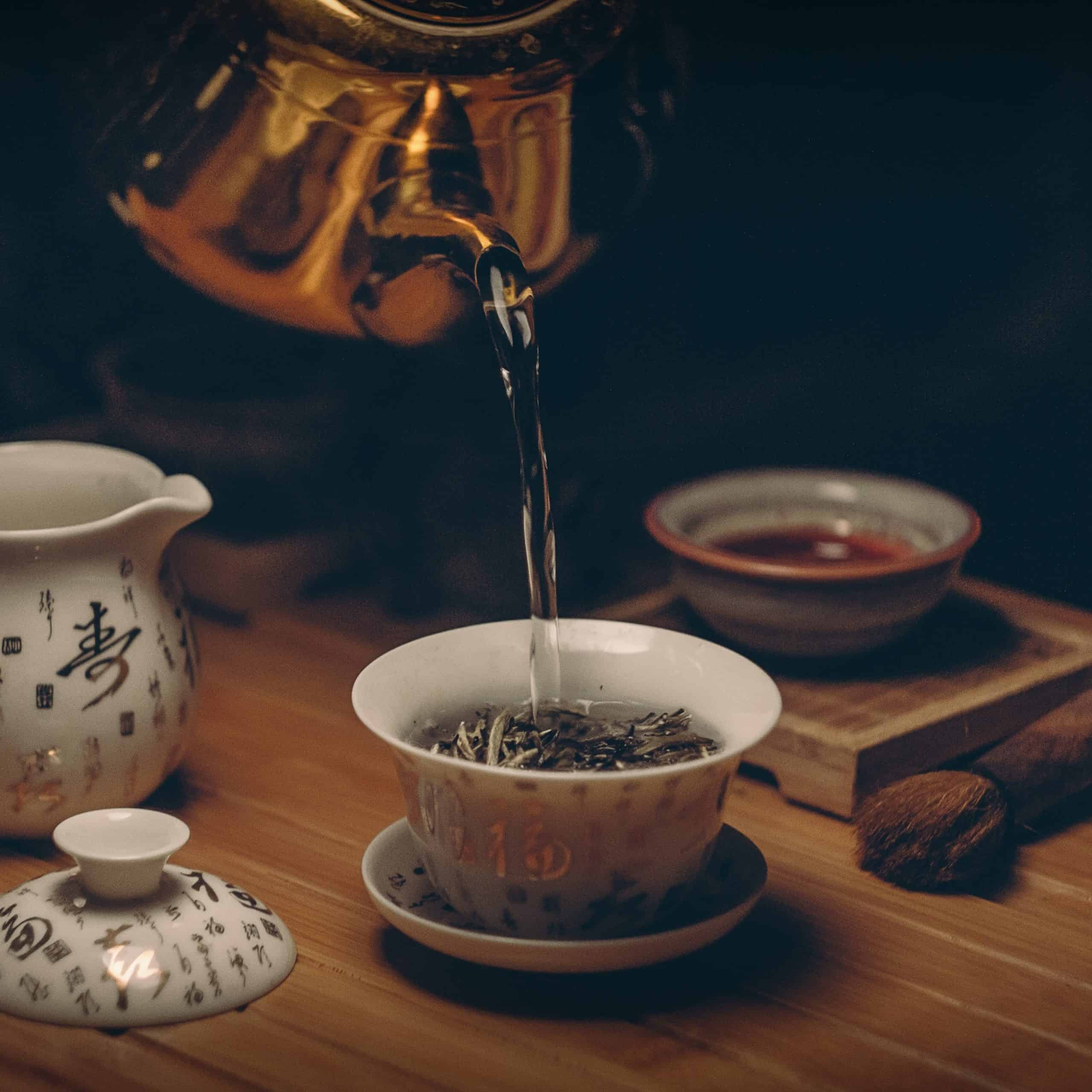 pouring hot water on tea