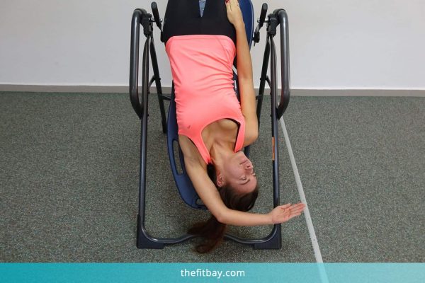 Young Woman Practicing On Inversion Table