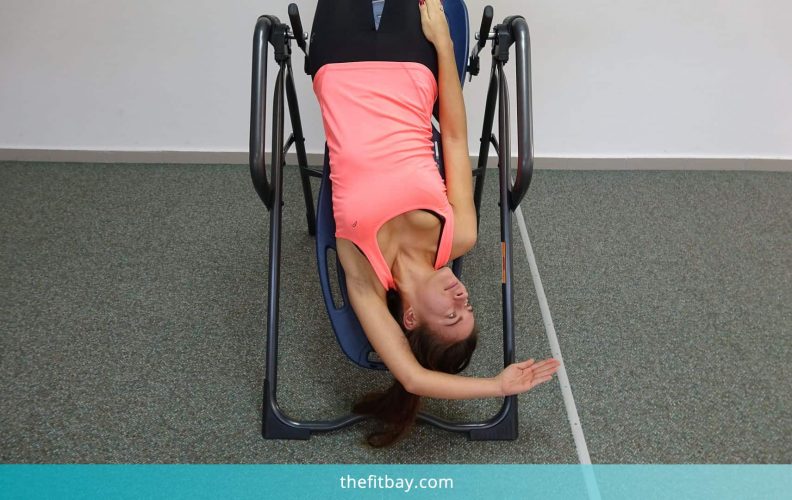 Young Woman Practicing On Inversion Table