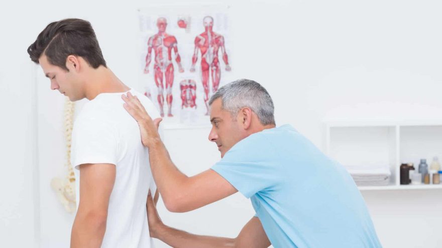 Can Inversion Tables Hurt Your Back? Doctor examining His Patient Back