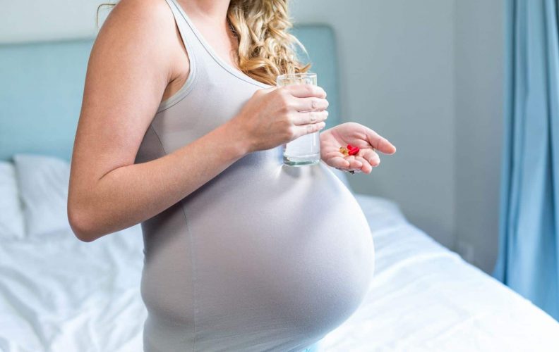 Pregnant Woman Takes Prenatal Multivitamin